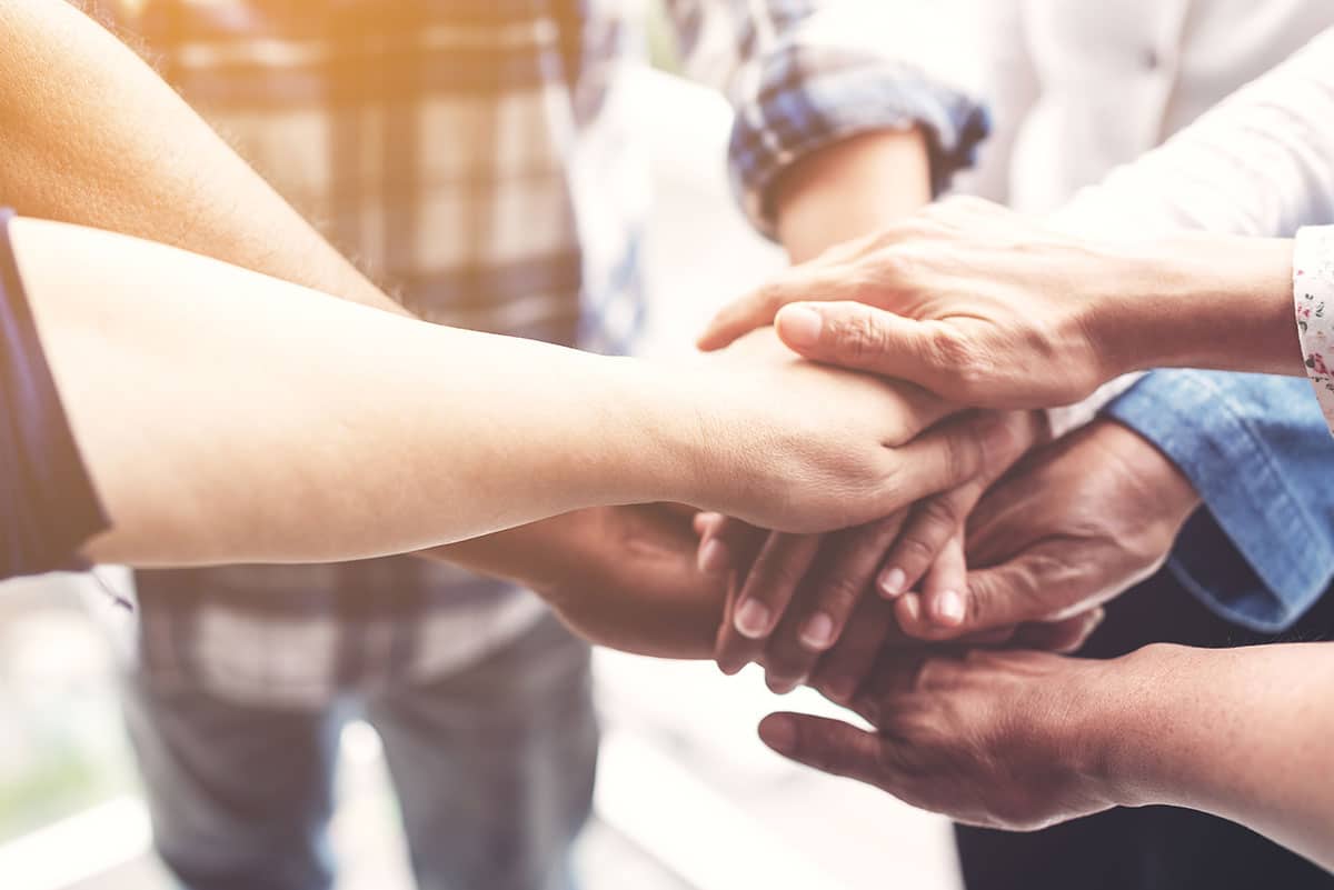 People hand assemble as a connection meeting teamwork concept