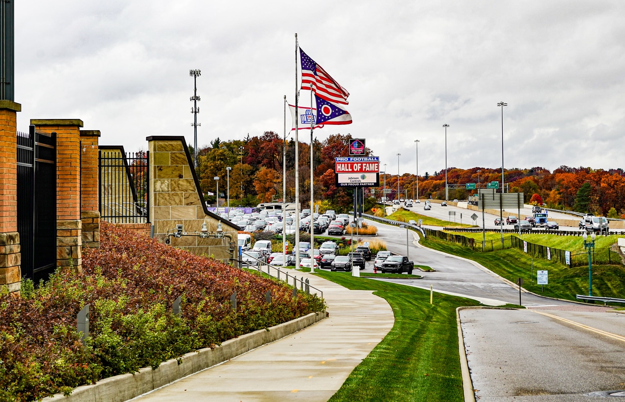 Ohio Urban Addiction Challenges: Addressing Substance Abuse Issues in City Environments 1 Canton, Ohio, USA---October 26, 2022: Off US Interstate-77, entrance to Tom Benson Football Hall of Fame Stadium, formerly Fawcett Stadium, and sports complex, including the Pro Football Hall of Fame in Canton, Ohio. A Hall of Fame flag under an American flag and Ohio State flag, waving from flag pole. Pro Football Hall of Fame signs. Landscape view.